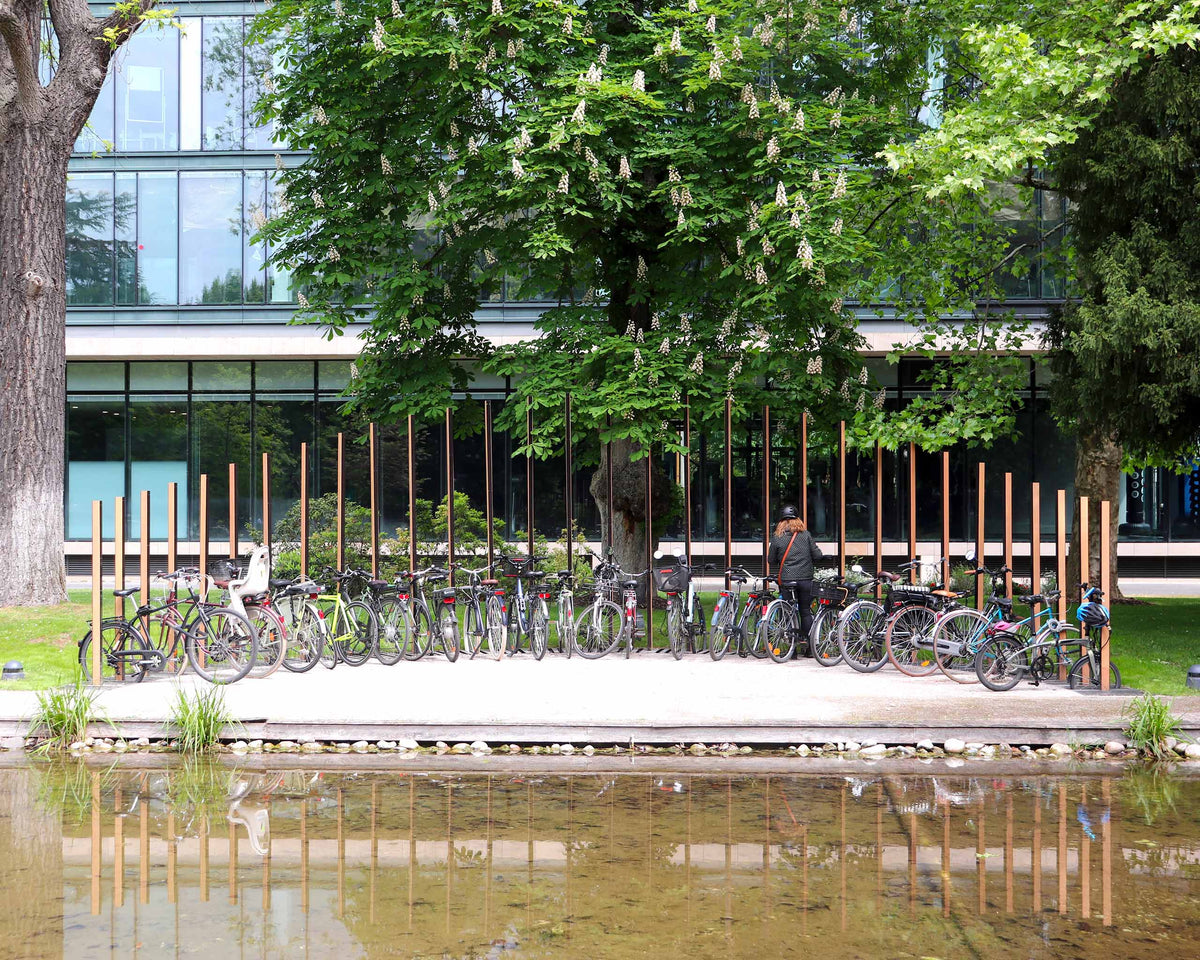 Dépose-vélos à structure verticale en demi-lune, geste sculptural qui habille le jardin