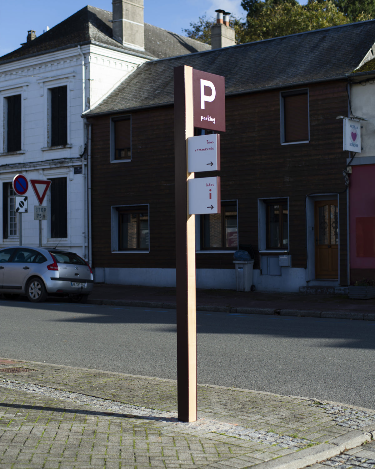 Signalétique d'identification des parkings en bois et métal, mutualisée avec des panneaux d'orientation piéton